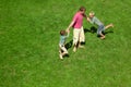 Two boys play with the adult a lawn. The top view.