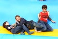 Two boys play on trampoline in summer amusement outdoor park