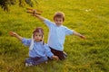 Two boys, playing with airplane on sunset in the park Royalty Free Stock Photo