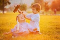 Two boys, playing with airplane on sunset in the park Royalty Free Stock Photo