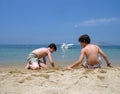 Two boys are playing on the beach