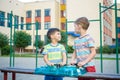 Two boys playing with a Beyblade, spinning top kid toy. Popular