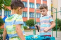 Two boys playing with a Beyblade, spinning top kid toy. Popular