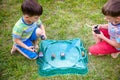 Two boys playing with a Beyblade, spinning top kid toy. Popular children game tournament.