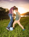 Two boys playing football in the field Royalty Free Stock Photo