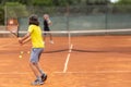 Two boys playing friendly tennis match on the court Royalty Free Stock Photo