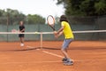 Two boys playing friendly tennis match Royalty Free Stock Photo