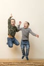 Two boys are playing in the house. children brothers playing together at home. movement and people concept - happy little girl Royalty Free Stock Photo