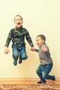 Two boys are playing in the house. children brothers playing together at home. movement and people concept - happy little girl Royalty Free Stock Photo