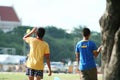 Two boys are playing kites at Sanam Luang, Thailand