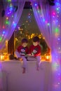 Two boys, playing on tablet on the window Royalty Free Stock Photo