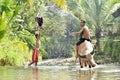 Two boys playing water splash to buffalo Royalty Free Stock Photo