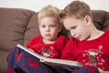 Two boys reading book