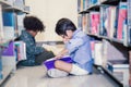 Two boys reading on the library floor Royalty Free Stock Photo