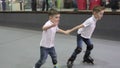 Two boys ride on the rollers on rollerdrome