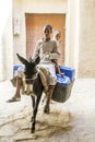 Two boys ride their donkey in Rissani in Morocco. Royalty Free Stock Photo