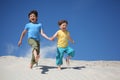 Two boys run on sand Royalty Free Stock Photo