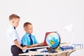 Two boys school computer desk globe Royalty Free Stock Photo