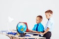 Two boys school computer desk globe education Royalty Free Stock Photo