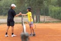 Two boys shake hands above the net on the tennis court Royalty Free Stock Photo