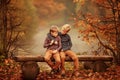 Two boys sitting on a bench by the pond. Royalty Free Stock Photo