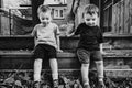 Two Boys Sitting Outside Together Royalty Free Stock Photo