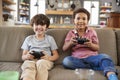 Two Boys Sitting On Sofa In Lounge Playing Video Game Together Royalty Free Stock Photo