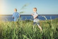 Two boys in striped t-shirts running out.