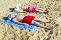 Two boys sunbathing at the beach Royalty Free Stock Photo