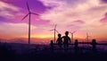 Two boys at sunset look at wind turbines Royalty Free Stock Photo