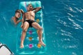 Two boys swim in the pool on an air mattress, happy childhood, summer concept Royalty Free Stock Photo