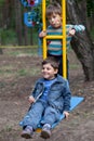 Two boys on a swing Royalty Free Stock Photo