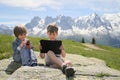 Two boys with tablet PC in Alps Royalty Free Stock Photo