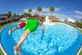 Two boys take a header into the pool