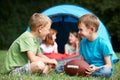 Two Boys Talking And Playing With American Football On Camping T Royalty Free Stock Photo
