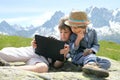 Two boys with tablet PC in mountains Royalty Free Stock Photo