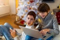 Two Boys Using Laptop by Christmas Tree Royalty Free Stock Photo