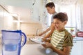 Two boys washing the dishes