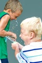 Two Boys in a Water Balloon Fight Royalty Free Stock Photo