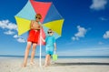 Two boys wear sunglasses stand on the beach under parasol Royalty Free Stock Photo