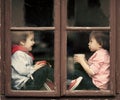 Two boys on the window, laughing and drinking tea Royalty Free Stock Photo