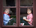 Two boys on the window, laughing and drinking tea Royalty Free Stock Photo