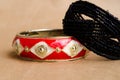 Two bracelets. Beaded bracelet and metal bracelet. Female bijutrei. A pair of jewelry. Red bracelet. Spring. Spring bloom.