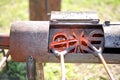 Two branding irons heating in a burner Royalty Free Stock Photo