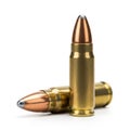 Two Brass and Copper Bullets on a White Background One Standing Upright the Other Leaning Royalty Free Stock Photo