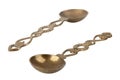 Two brass vintage spoons on white