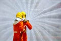 Two brave firefighter using extinguisher and water from hose for fire fighting, Firefighter spraying high pressure water to fire, Royalty Free Stock Photo