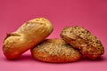 Two bread rolls arranged diagonally on pink studio surface Royalty Free Stock Photo