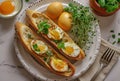 two bread sticks with eggs on a white plate with some herbs