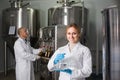 Two brewery workers on beer factory. Royalty Free Stock Photo